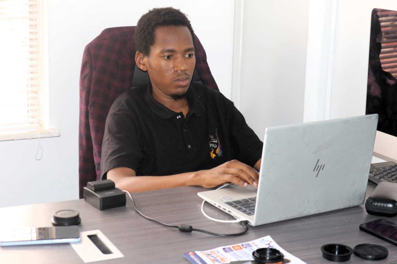 Kevin Githinji working at a laptop